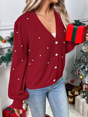 Red acrylic knit cardigan with pearl embellishments and crystal buttons, V-neck, long sleeves.