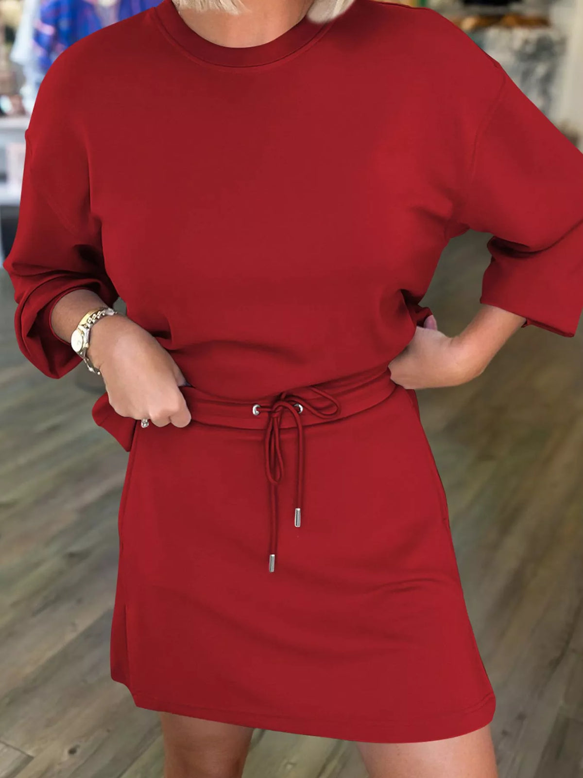 Deep red drawstring sweatshirt and skirt set with crew neck and 3/4 sleeves.