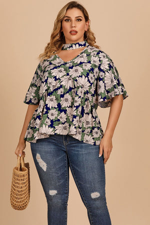 Dark blue floral peplum blouse with keyhole neckline and flutter sleeves