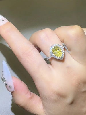Yellow pear-cut moissanite halo ring with diamond band