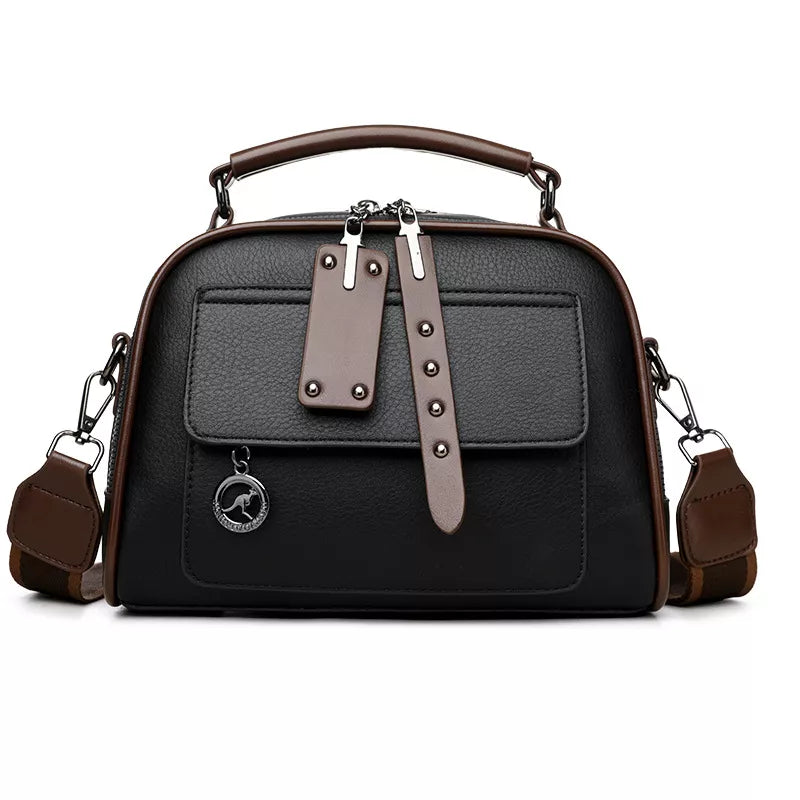 Chic structured black crossbody bag with adjustable strap and brown trim.