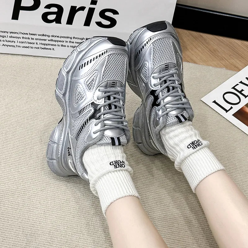 Silver lace-up sport platforms with breathable mesh and chunky soles.
