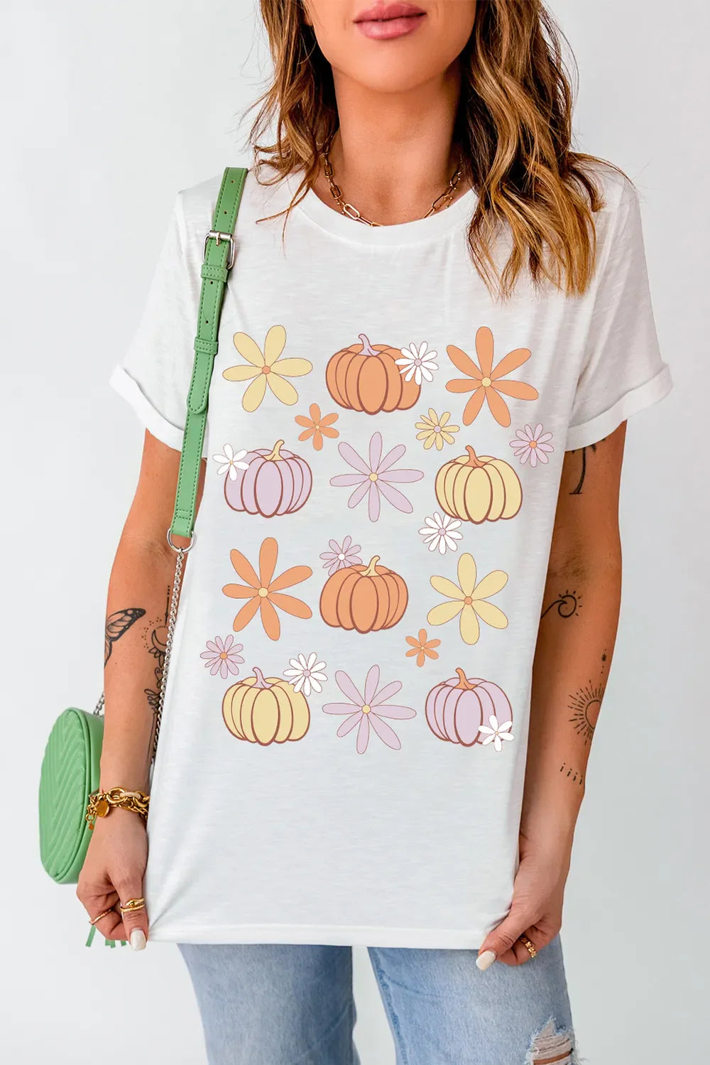 White t-shirt with a retro pumpkin and flower graphic print.