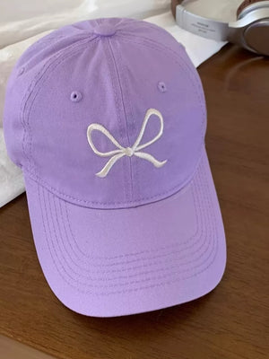 Lavender baseball cap with white embroidered bow detail