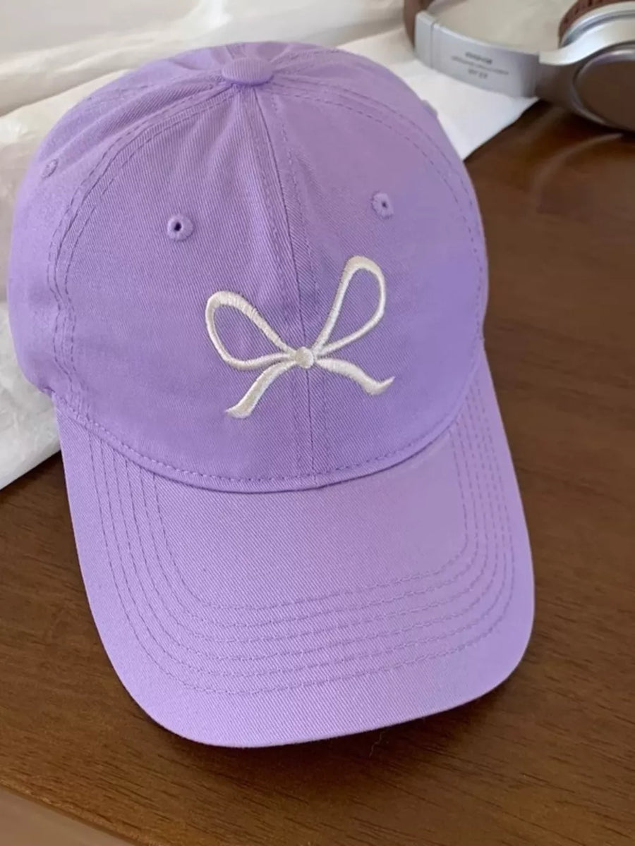 Lavender baseball cap with white embroidered bow detail