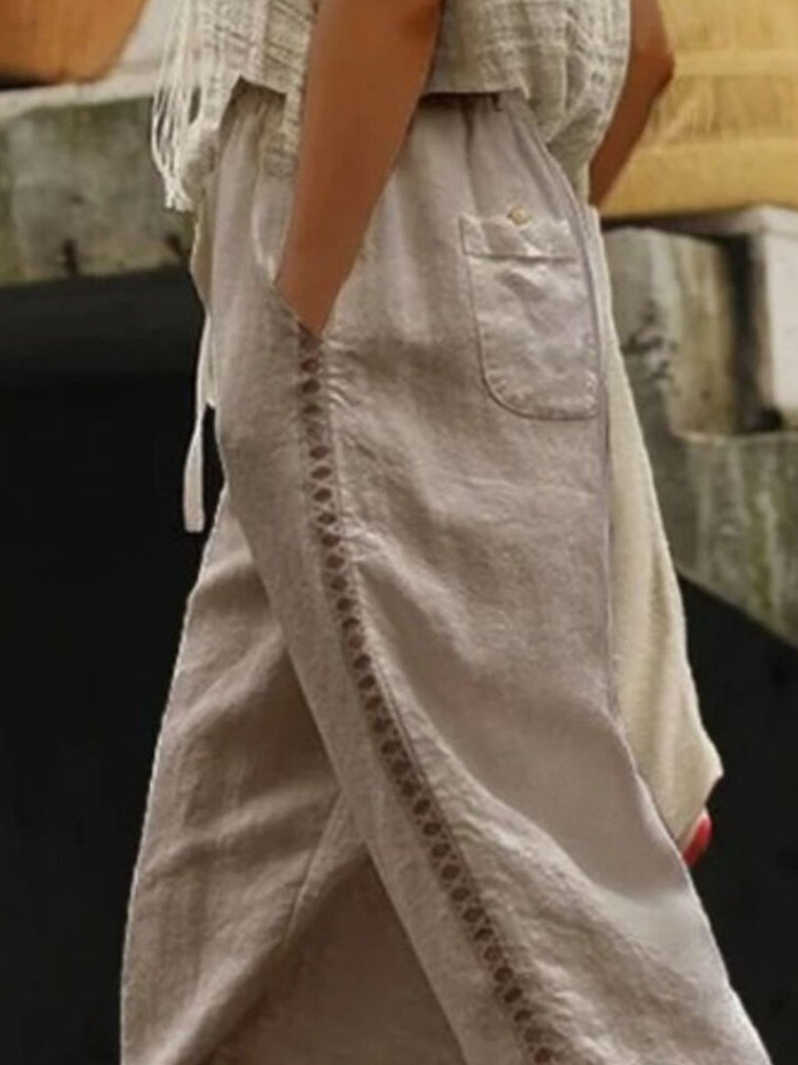 Khaki relaxed cropped pants with hollow out trim detail and a pocket.