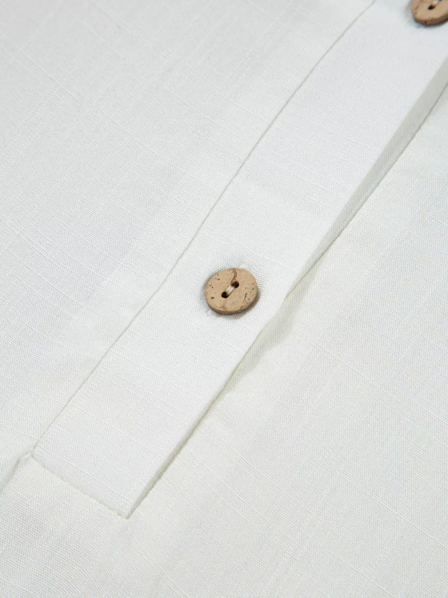 White linen shirt with wooden buttons and a button-up placket.