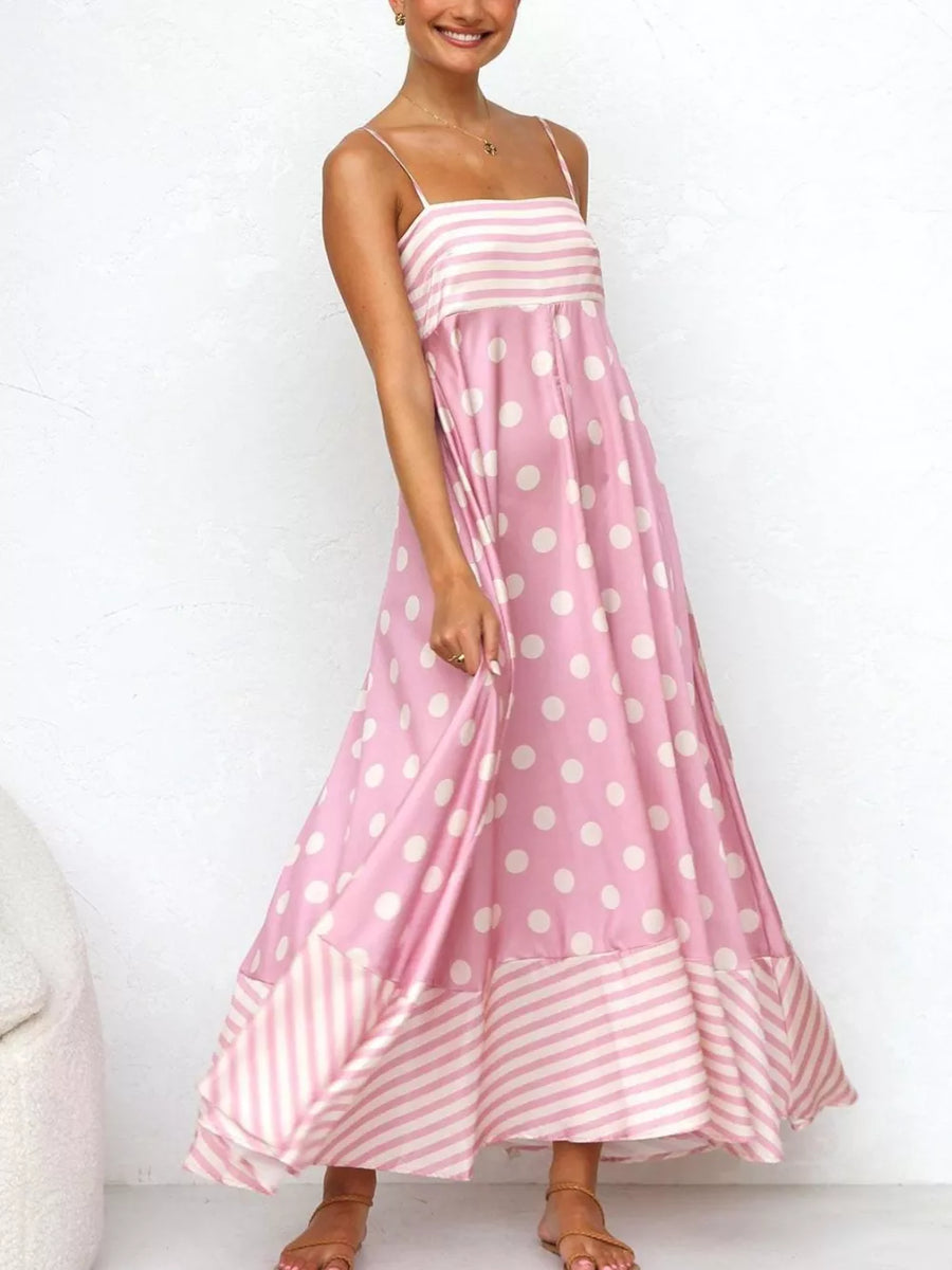 Blush pink maxi dress with spaghetti straps, polka dot print and striped hem.