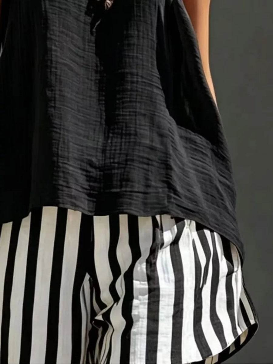 Black textured tank top with black and white striped shorts