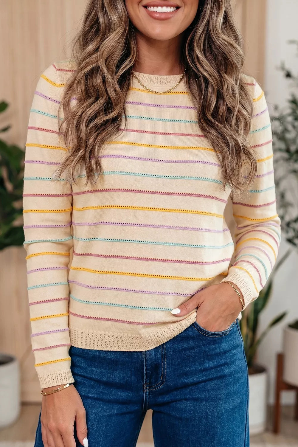 Beige crewneck sweater featuring stretch and striped