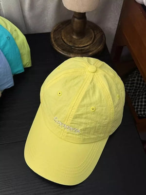 Yellow cotton baseball cap with embroidered logo and curved brim