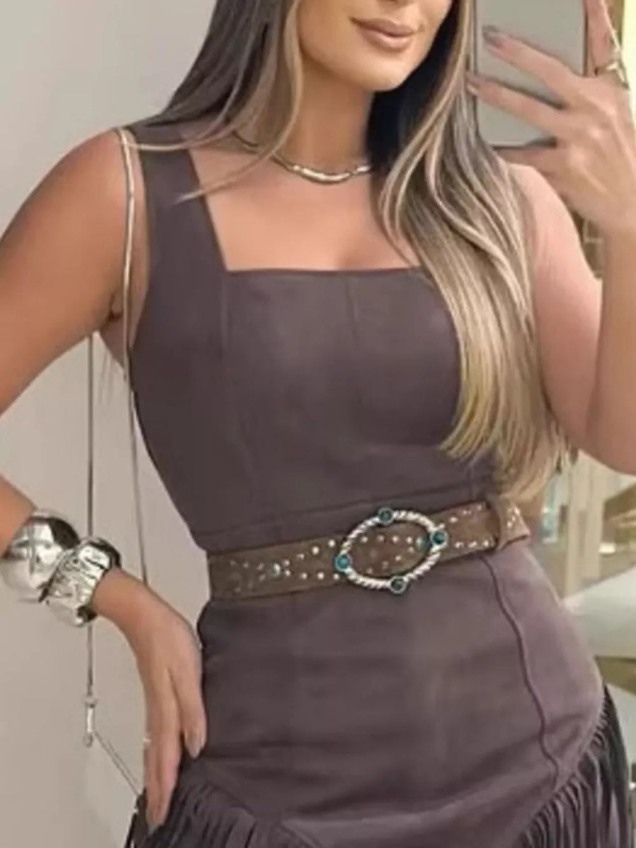 Brown asymmetrical mini dress with fringe detail and square neckline.