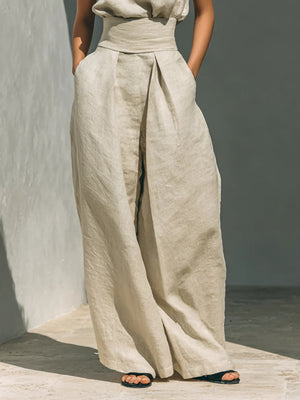 Ivory linen mock-neck top and wide-leg pants set with a high waist and pleats.
