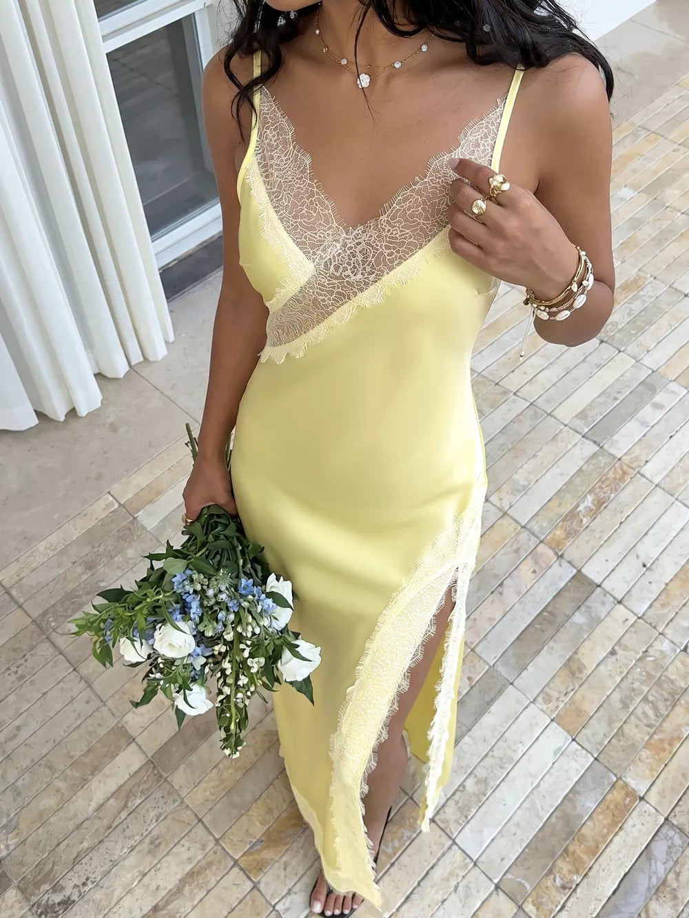 Yellow lace-trimmed midi slip dress with a side slit and V-neck.