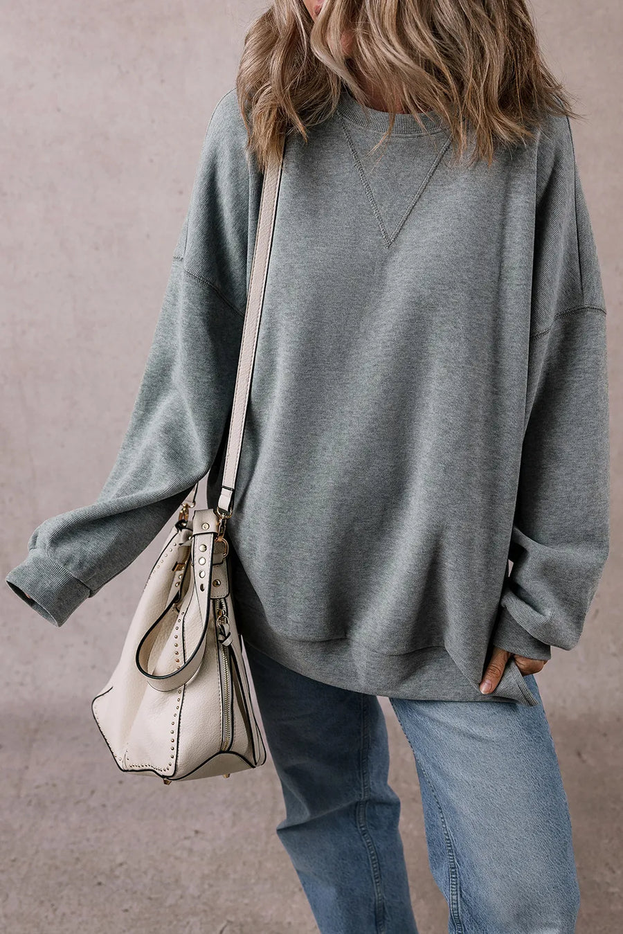 Relaxed fit dark gray ribbed sweatshirt with crew neck and V-stitch detail.