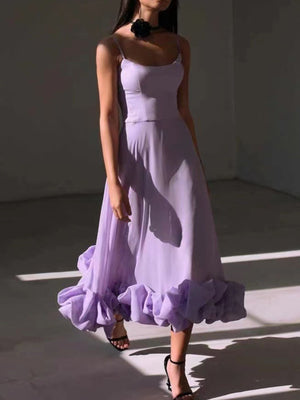 Lavender midi dress with spaghetti straps and a ruffled hem.