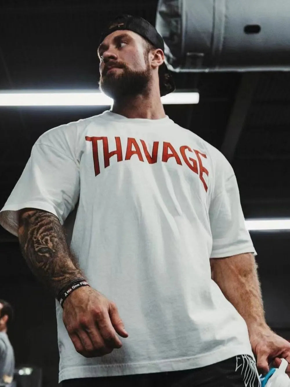 White oversized graphic tee with red THAVAGE print, short sleeves, crew neck.