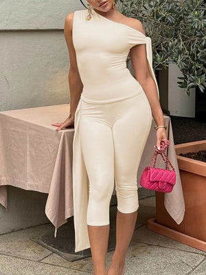 Apricot asymmetrical one-shoulder top with capri pants.