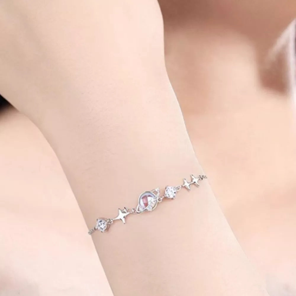 Celestial Zircon Star Adjustable Bracelet with planet charm and sparkling stones.