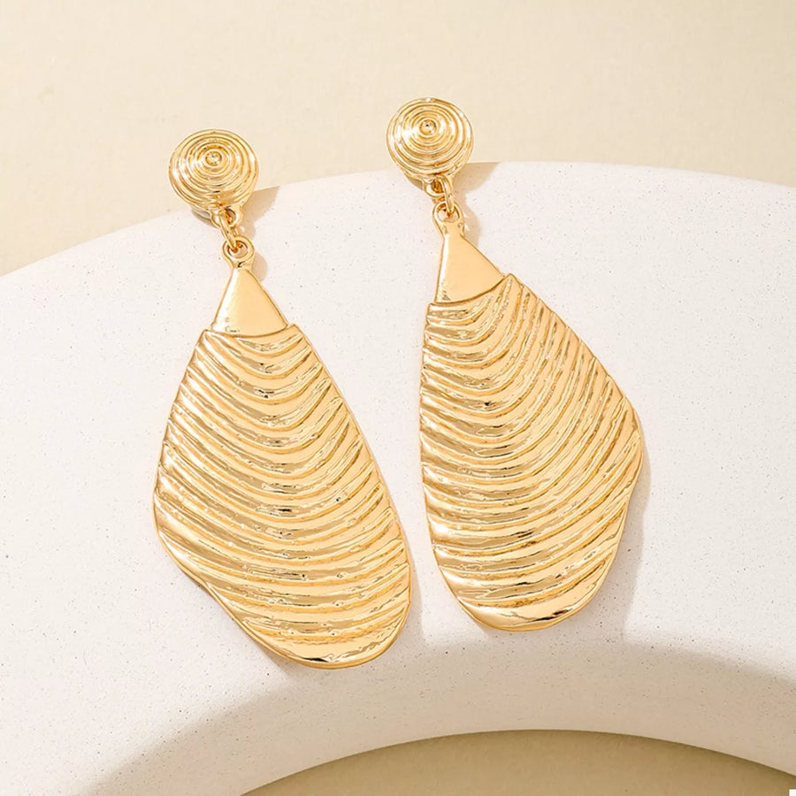 Textured dangle earrings in gold with a wavy pattern and spiral studs.