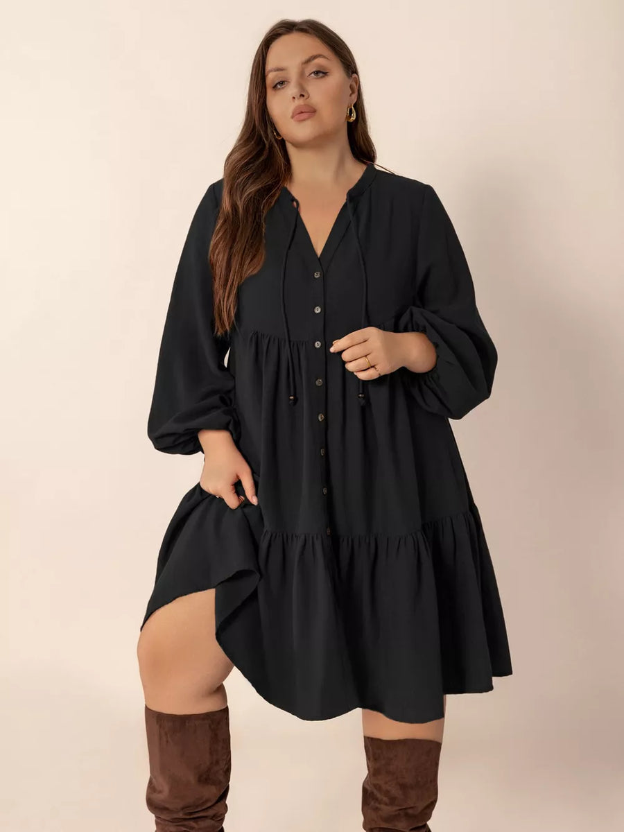 Black plus-size balloon sleeve dress with button front and tiered skirt