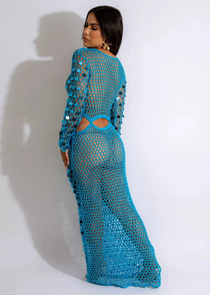 Blue mesh cutout maxi gown with sequin details and long sleeves.