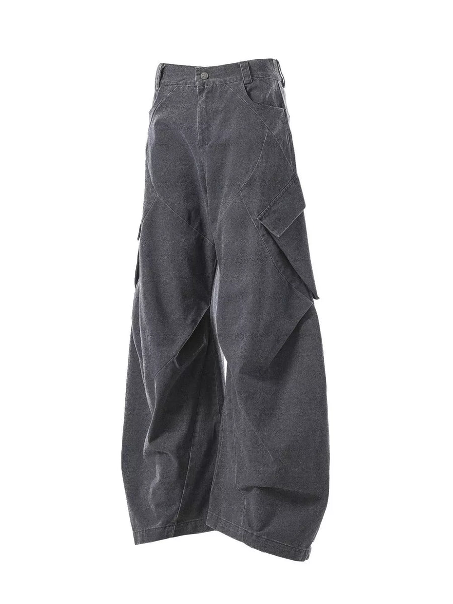 Textured paneled cargo pants in dark gray with baggy fit and multiple pockets.