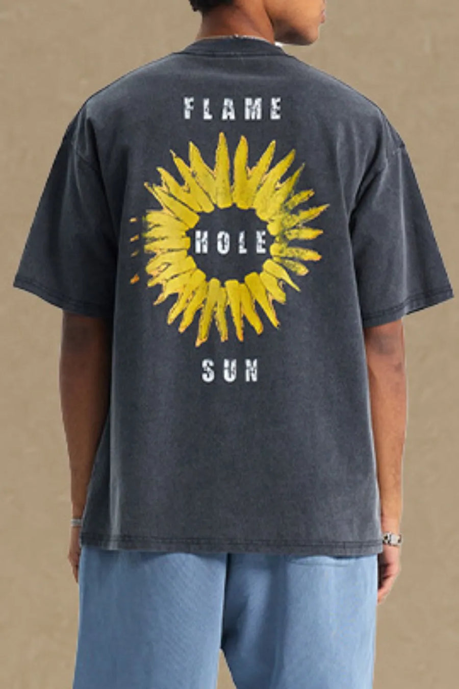 Black distressed graphic tee with a yellow sunflower print and text.