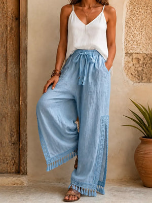 wide-leg pants in light blue featuring drawstring waist and flared fit