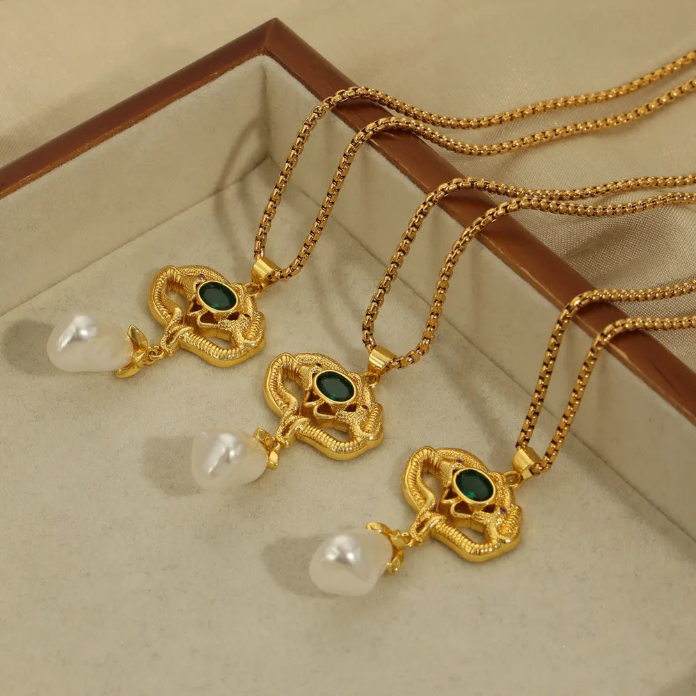 Gold botanical pearl drop pendant necklace with green gemstone detail