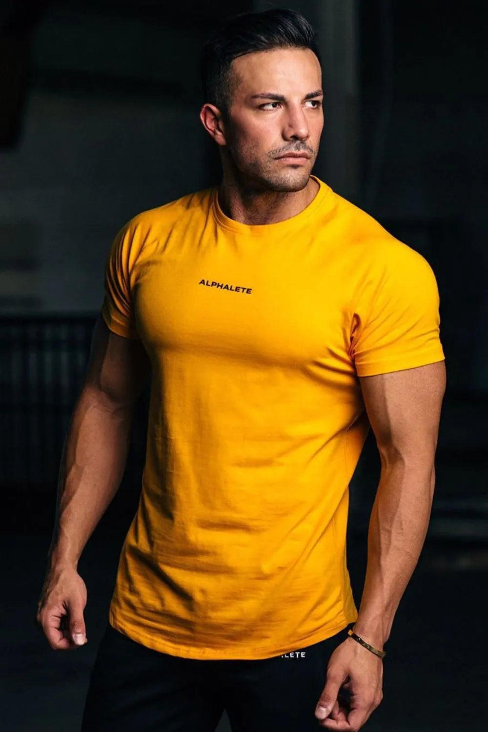Gold crew neck athletic t-shirt with small black logo detail on chest