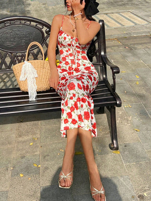 Women's white floral midi dress with red roses and tie-front detail, spaghetti straps.