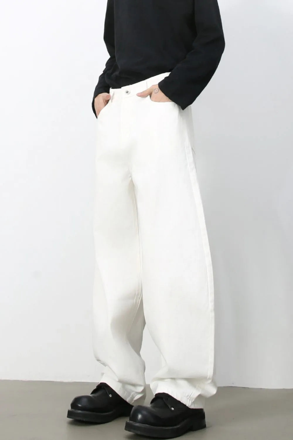 Sculpted ivory white denim balloon trousers with a relaxed fit and wide leg.