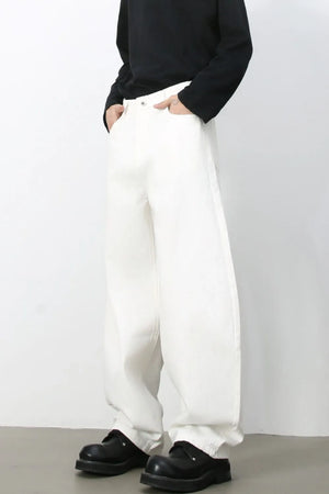 Sculpted ivory white denim balloon trousers with a relaxed fit and wide leg.
