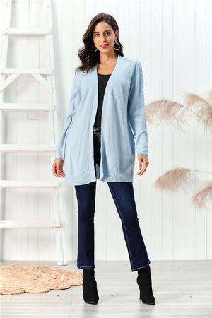 Light blue cable knit open front cardigan with braided sleeve detail.