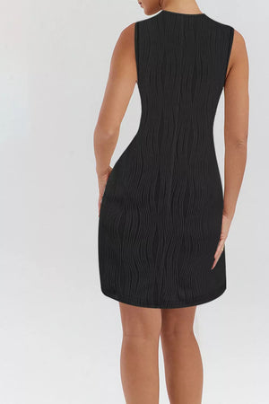 Black textured mini dress with V-neck and ring straps, cotton blend.