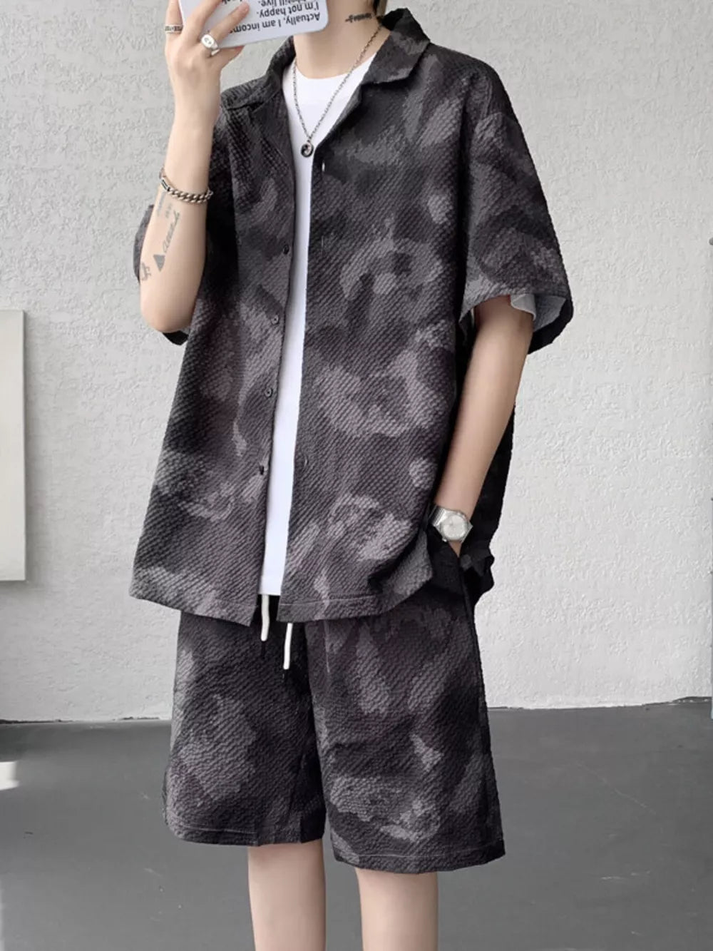 Men's dark gray camouflage short sleeve shirt and drawstring shorts set.