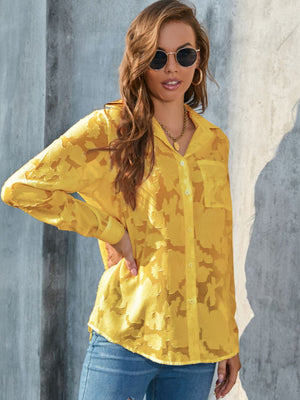 Yellow sheer button-down blouse with floral embroidery and long sleeves.