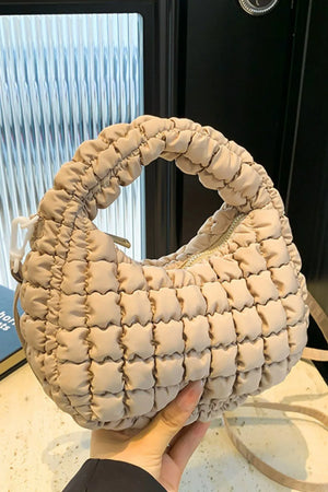 Padded crescent crossbody bag in Khaki with sculptural texture and ruched handle.