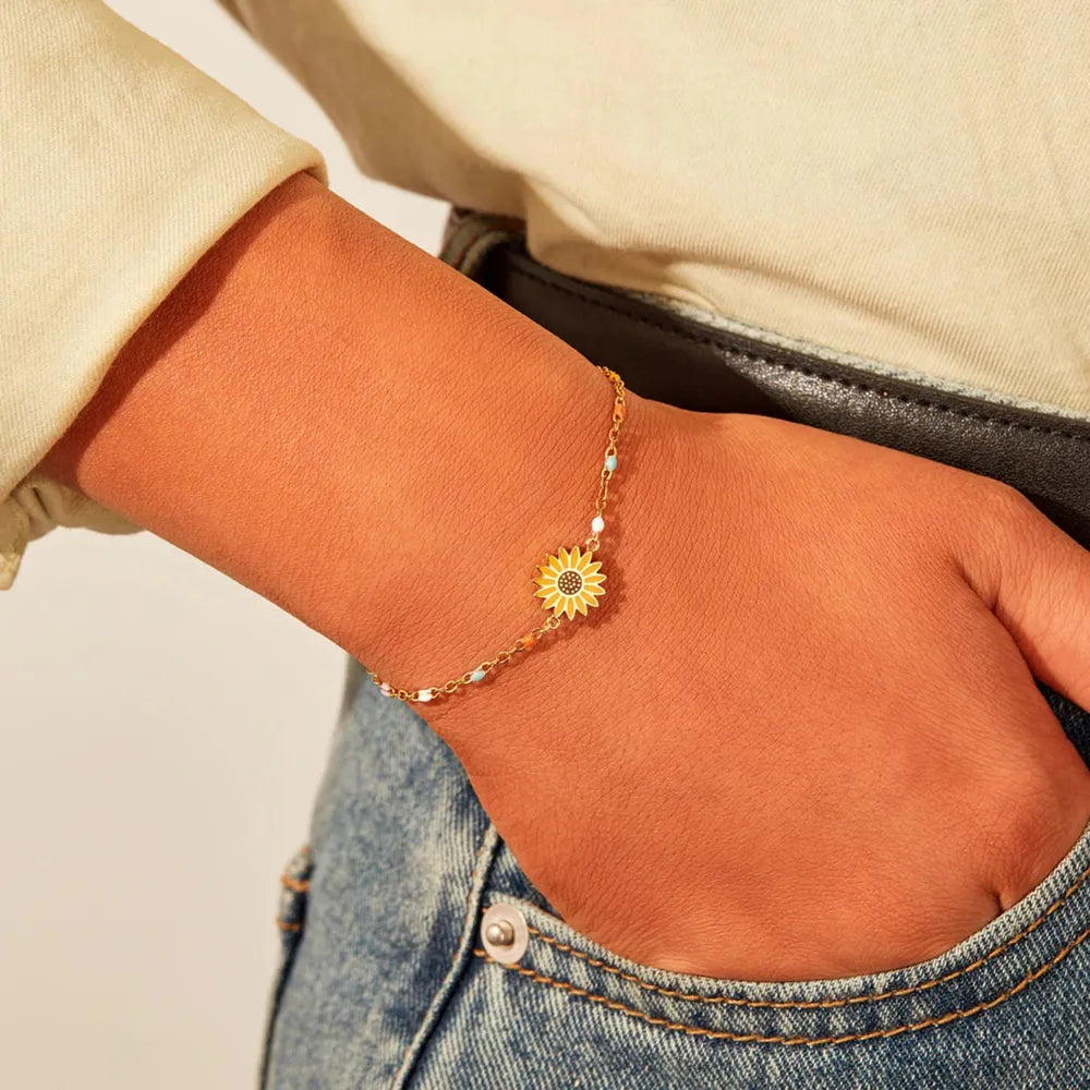 Gold sunflower charm beaded bracelet with colorful accent beads.