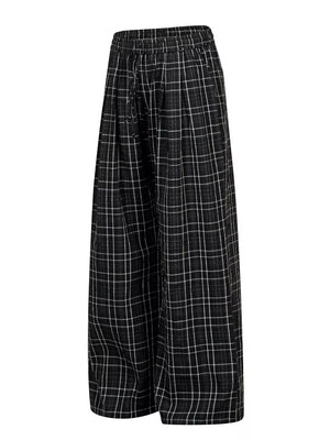 Plaid wide-leg sweatpants with drawstring waist in black and white check.
