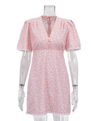 Pink floral print mini dress with v-neck, short puff sleeves, and lace trim