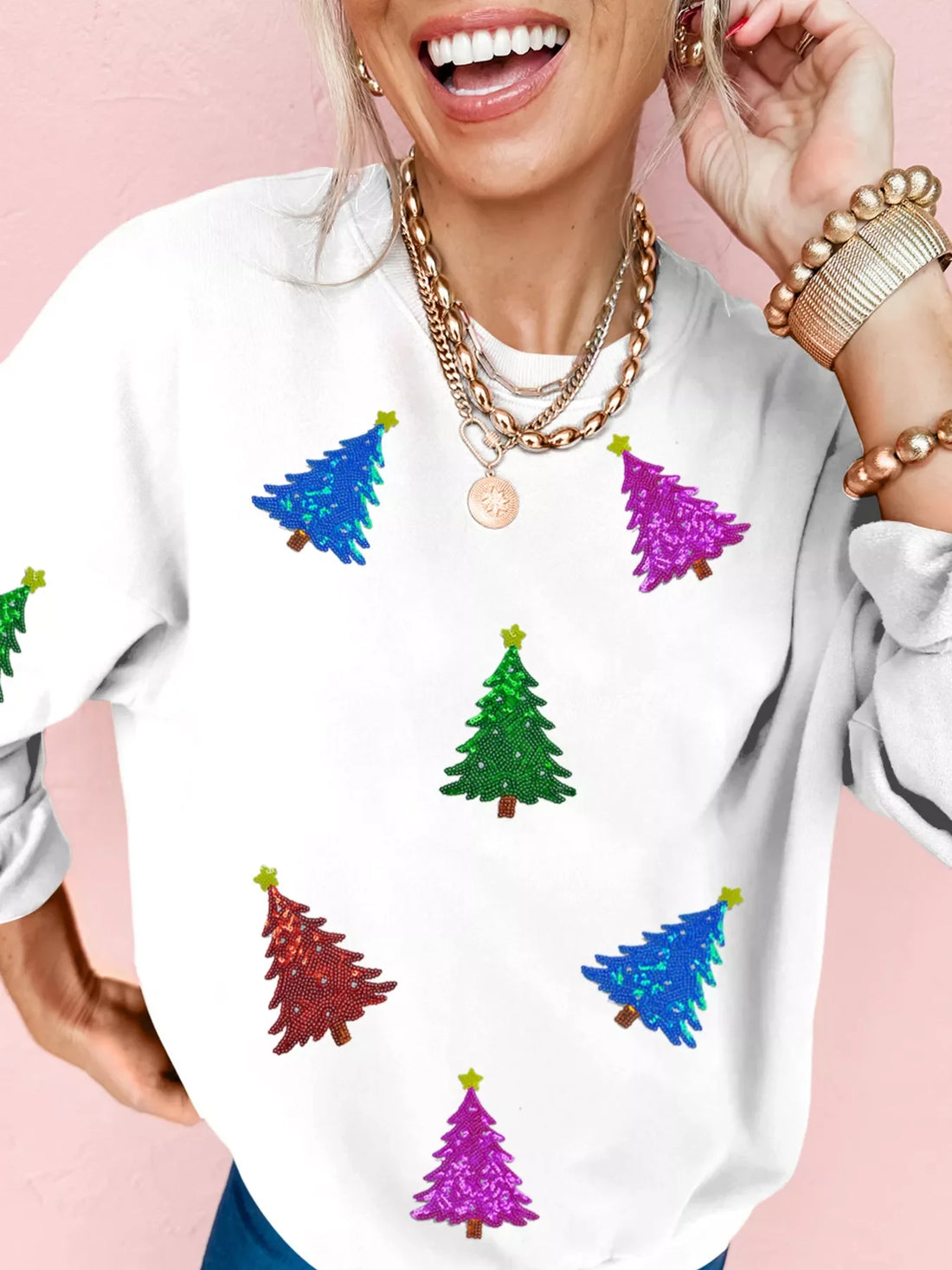White sweatshirt with colorful sequin Christmas trees and stars.