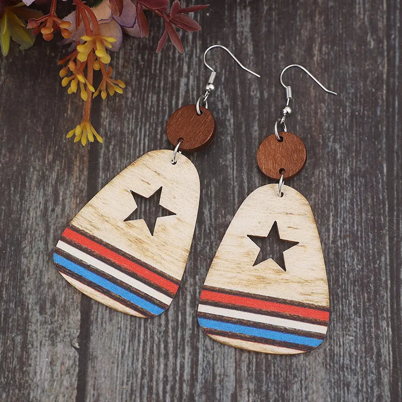 Star cutout wooden dangle earrings with red, white, and blue stripes.