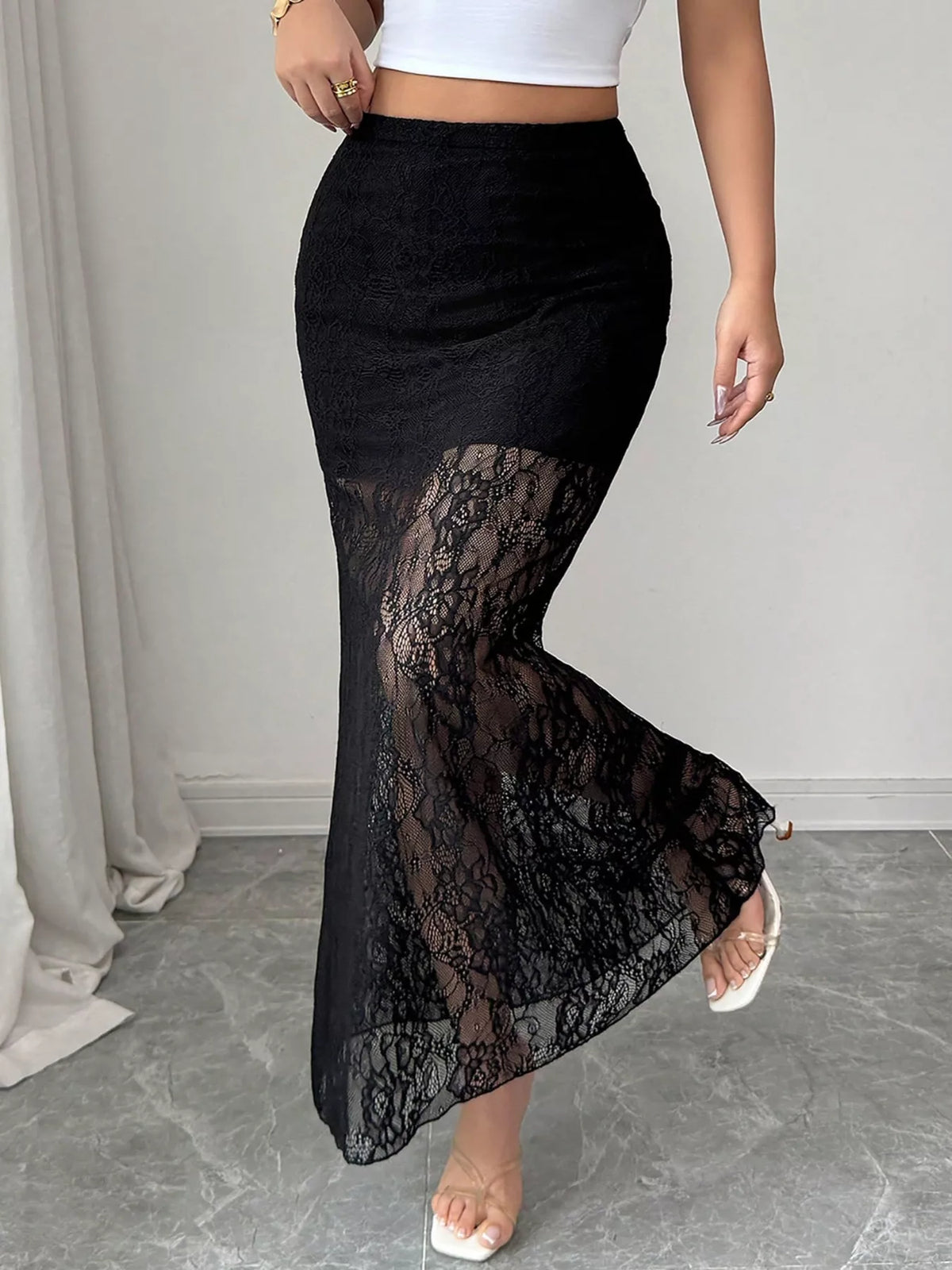 Black lace maxi skirt with sheer lace panel and lace trim detail.