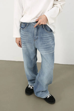 Oversized light wash denim jeans with fade details and a relaxed fit.