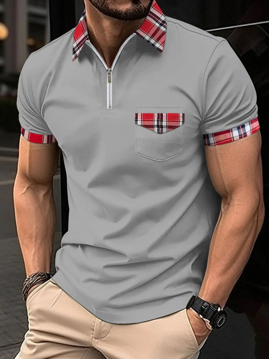 Gray zip polo shirt with plaid collar, pocket trim, and sleeve cuffs.
