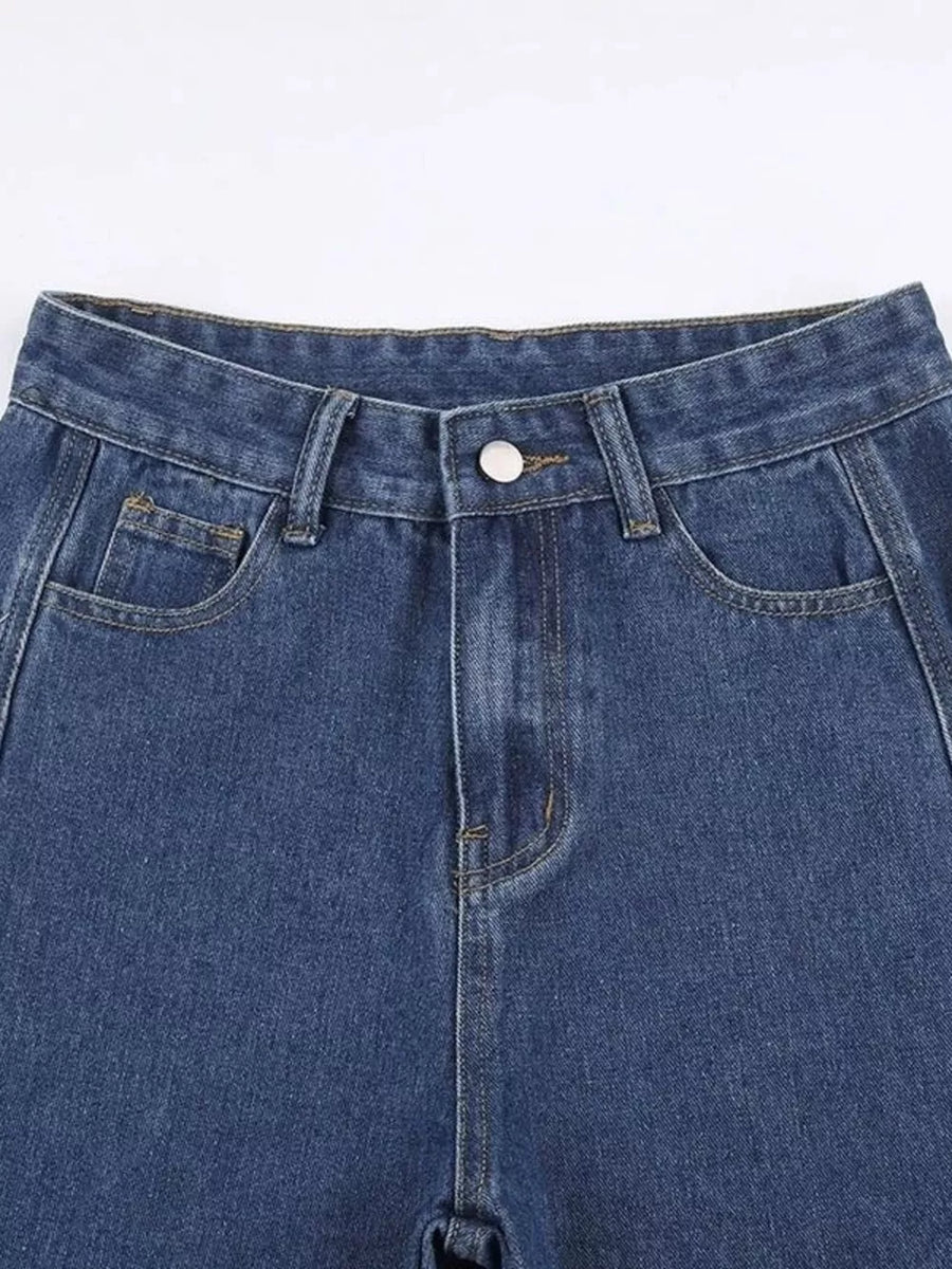 Blue denim jeans with distressed side cutouts and lace-up detail.
