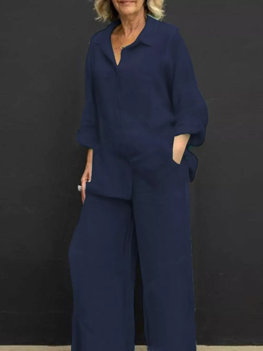 Navy blue relaxed two-piece set with buttoned collared top and wide-leg pants.