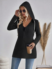 Black cable-knit hooded zip jacket with white drawstrings and contrast textured bodice.